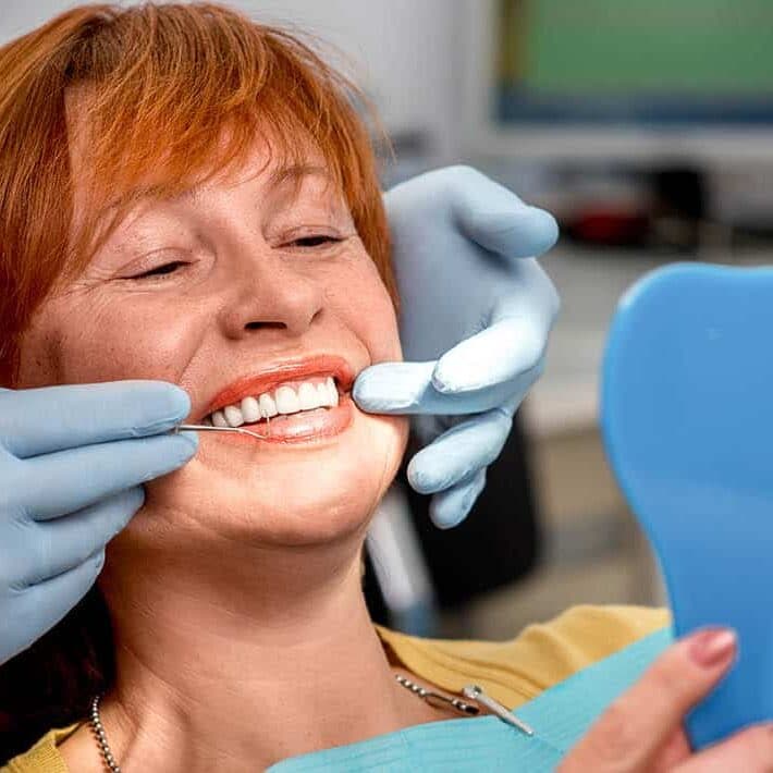 A smiling BlueDot Dental patient after her visit